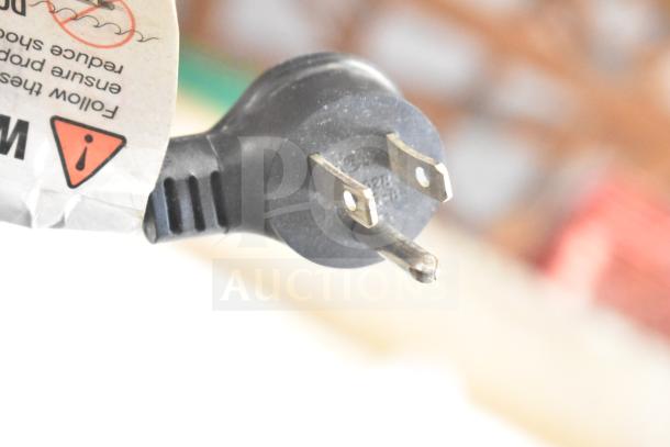 Close-up of a Crane 5800-4 vending machine power plug with safety warning label. 115 Volts, 1 Phase.