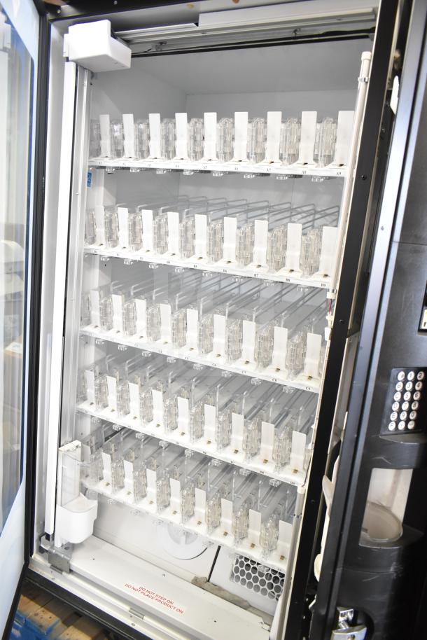 Crane 5800-4 commercial vending machine with bill acceptor. Features multiple shelves, keypad, 115V, 1 phase, tested & working.