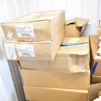 13 boxes of Current Evolve LED flood lights, original packaging, stacked on a pallet, visible condition varies.