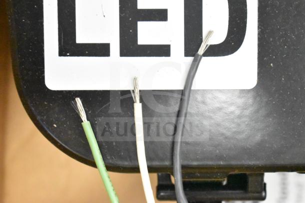 Original box with 13 Current Evolve LED Flood Lights. Visible wires for installation.