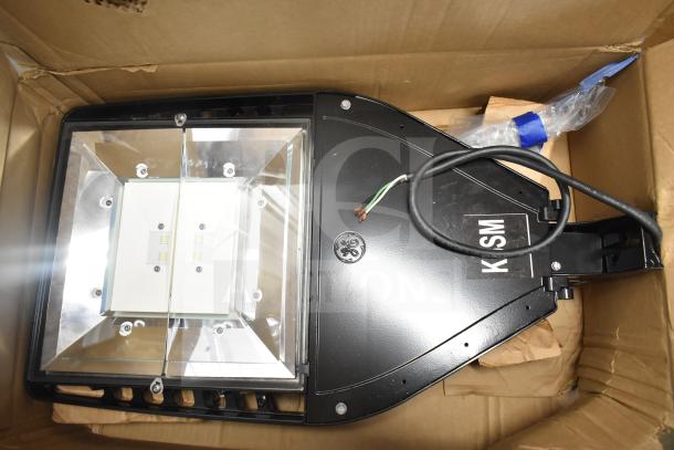 Evolve LED flood light in original box, includes wiring and mounting parts, labeled "KSM," new condition.