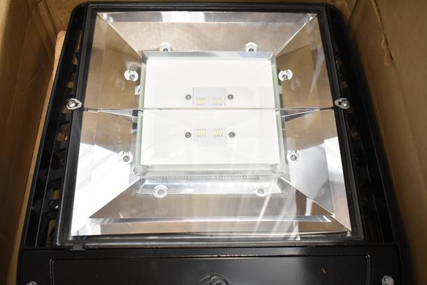 Original Evolve LED Flood Light in pristine condition, boxed. Features adjustable LEDs and durable casing. Auction includes 13 units.