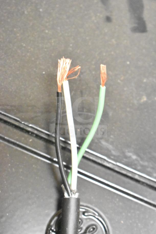 Three exposed electrical wires: black, white, and green. Part of Evolve LED Flood Lights auction lot, in original packaging.