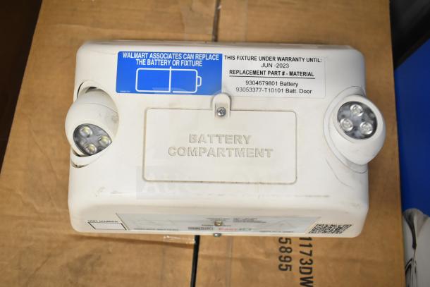 DualLite LED Emergency Light with dual adjustable heads, visible warranty tag expiring June 2023, and battery compartment.