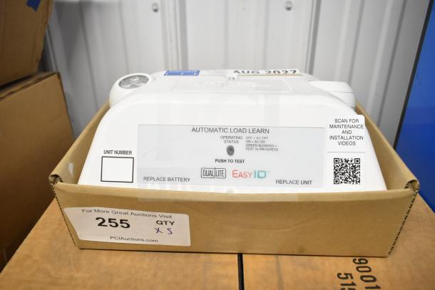 DualLite LED emergency light in box, features automatic load learn. Includes QR code for maintenance and installation.