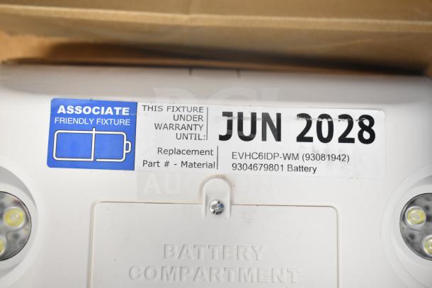 DualLite LED emergency light with warranty until June 2028. Model EVHC6IDP-WM. Includes battery compartment tag.