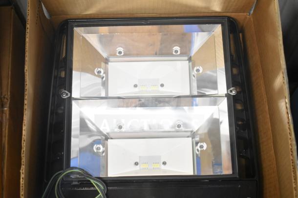4 Evolve LED Flood Lights in original box. Features dual LED panels, reflective casing. New condition.