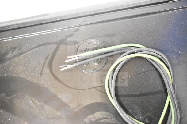 Black box with green and black wires, embossed logo visible. Contains 4 Evolve LED Flood Lights in original packaging.