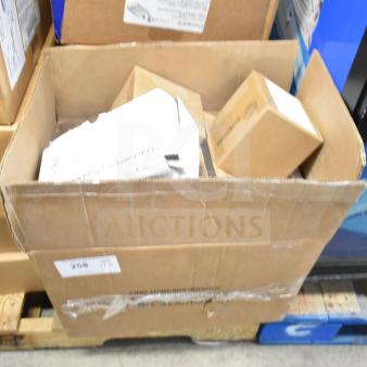 Cardboard box with 16 assorted items including LED emergency light battery backup, DualLite double remote heads, and exit signs.