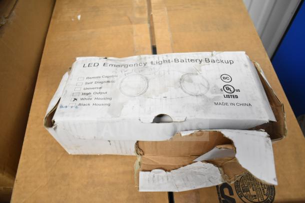 Box of LED Emergency Light Battery Backup, damaged packaging, UL listed, options for high output, white or black housing.