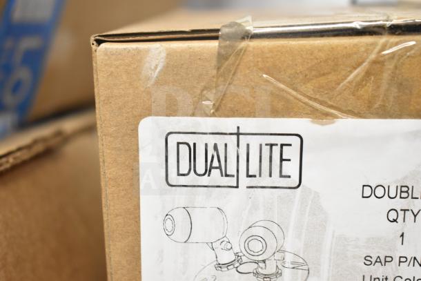 Box labeled "DualLite" containing LED emergency light battery backup and DualLite double remote heads, part of 16-item auction lot.