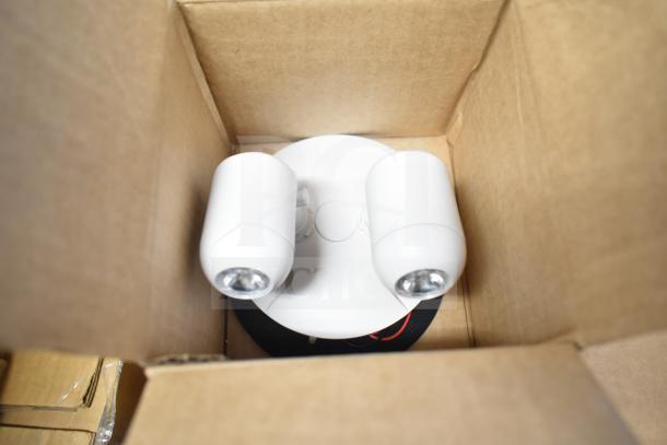 Boxed DualLite double remote heads, part of 16-item lot. Includes LED emergency light and exit signs. New condition.