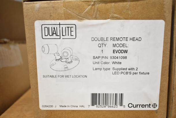 Set of 16 DualLite items including LED emergency lights, double remote heads, and exit signs. Model EVODW, suitable for wet locations. Box label shows SAP P/N 93041098, unit color white.