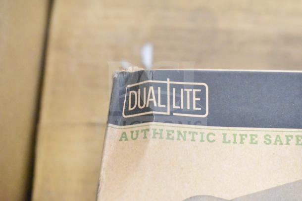 DualLite box with branding and "Authentic Life Safety" text, showing corner wear. Contains emergency lighting items.