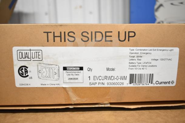 Box labeled DualLite LED emergency light, model EVCURWDI-0-WM. White finish, red letters, suitable for damp locations.