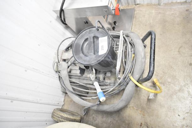 CapSpray Compressor/Pump with hoses and handle, in used condition. Visible label "259".