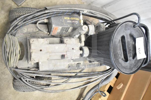 CapSpray compressor/pump with attached hoses, showing visible wear. Includes control panel and black cylindrical filter. Item tag reads "259".