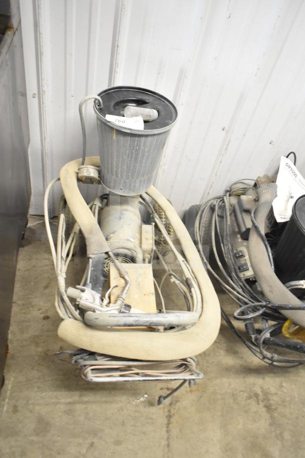 SprayTech 1075 Airless Spraying System, used condition, with attached hoses and cables, auction tag visible on top.