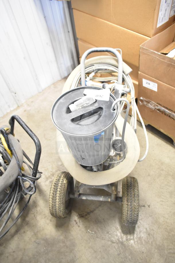 SprayTech 1075 Airless Spraying System, wheeled base, handle, hoses; visible wear, label marked 260.