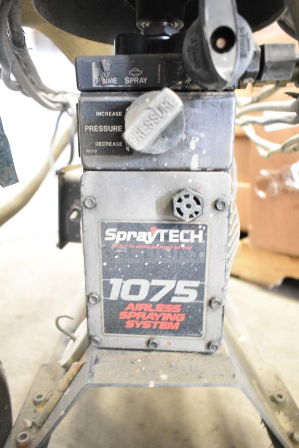 SprayTech 1075 Airless Spraying System, well-used condition, features pressure controls and visible brand markings.