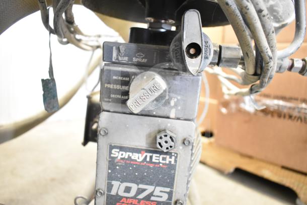 SprayTech 1075 Airless Spraying System, used condition, features pressure control, visible wear on knobs and casing.