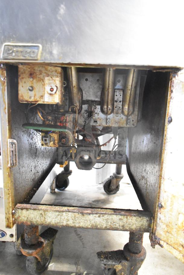 Pitco Frialator SG14 fryer, natural gas, 110,000 BTU, commercial use, visible wear on interior components and casters.