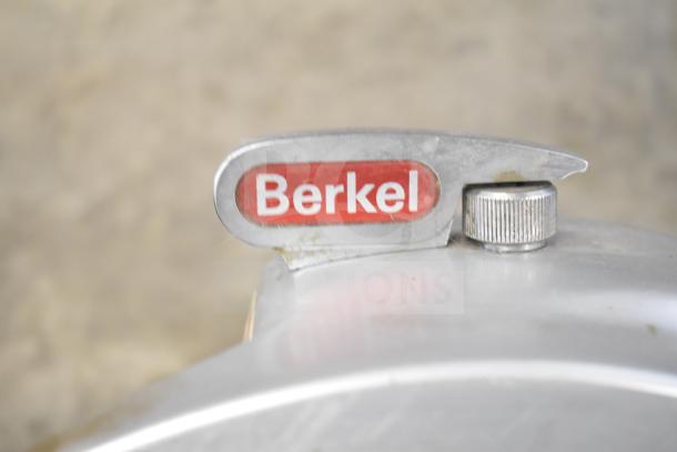 Berkel 818 meat slicer detail; features sharpener and branded badge, 115V, 1 Phase. Ideal for commercial use.