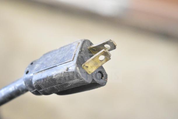 "Close-up of a Berkel 818 meat slicer's power plug showing wear, indicating 115V, 1 phase connection, ready for auction."