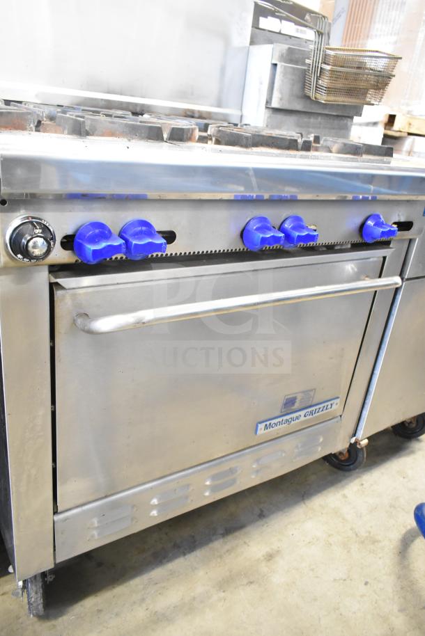 Montague Grizzly commercial gas range, 6 burners, with oven, back splash, blue knobs, stainless steel, used condition.