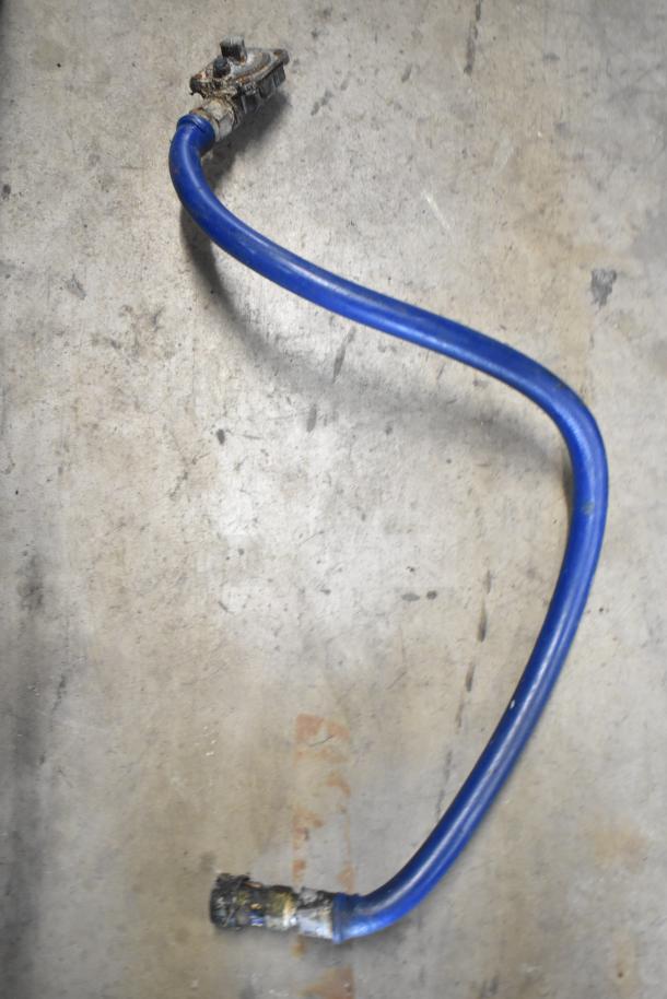Blue gas hose on concrete floor, showing wear at connectors, part of Montague Grizzly Range.