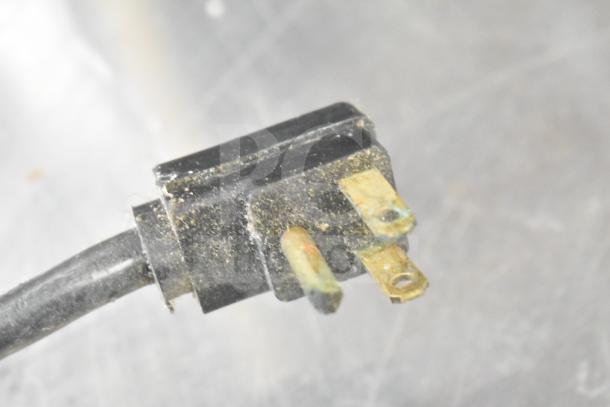Close-up of electrical plug for Perlick BC48 Commercial Back Bar Bottle Cooler showing visible wear and dust.
