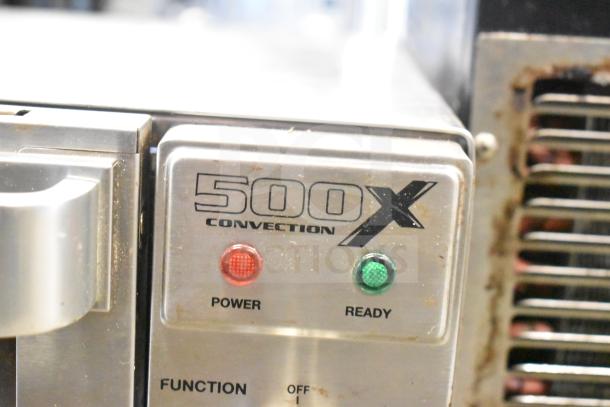 Waring WCO500X half-size countertop convection oven with power and ready indicators. Model number visible. Condition shows typical wear.