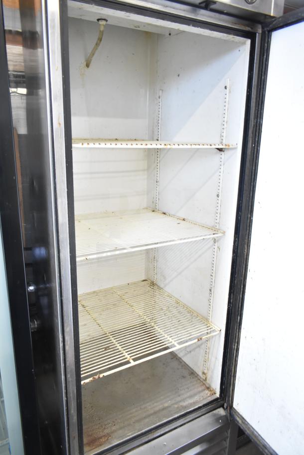 True T-23 Commercial Single Door Reach-In Cooler, model T-23, shows interior shelves; 115 volts, 1 phase, used condition.