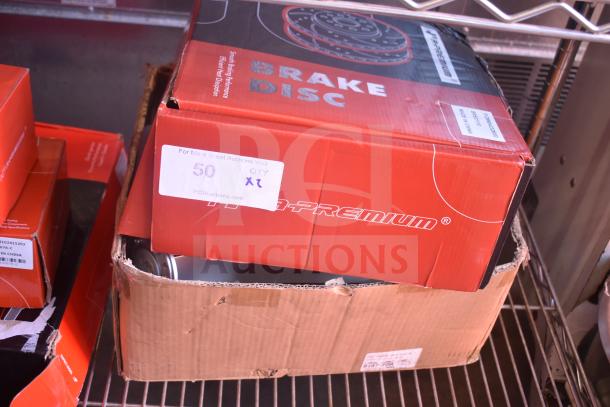 Two boxes labeled "Brake Disc" in original packaging, one slightly damaged. Tags indicate auction lot "50, Qty 2".
