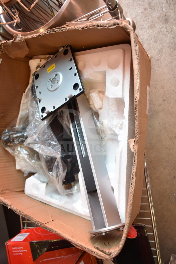 Cardboard box with new scratch and dent items including a brake disc, partially unpacked, with protective foam.
