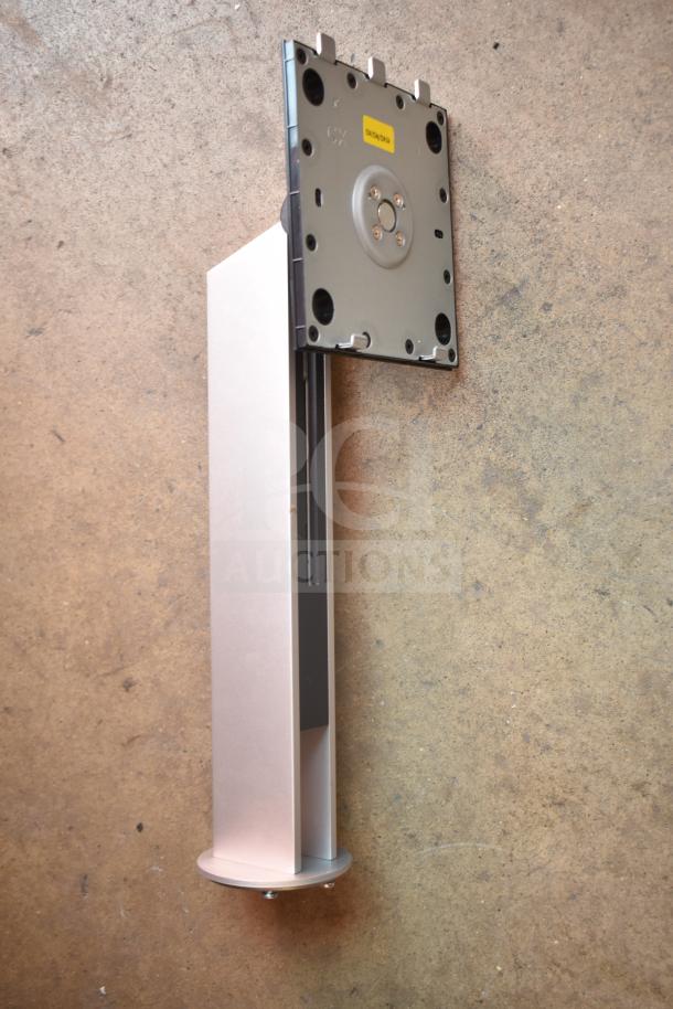 Silver metal bracket with a top mounting plate featuring a yellow label; minor surface imperfections visible.
