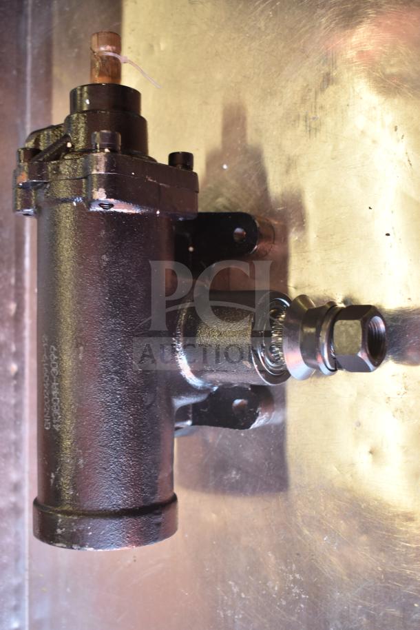 Brand new hydraulic brake component, black finish, minor scratches visible. Includes visible markings and hardware.