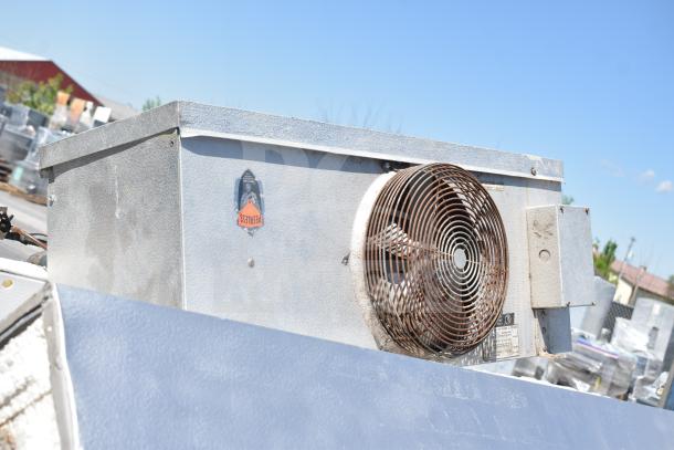 Walk In Box with Evaporator Fan, metal exterior, visible Peerless label, weathered condition, ideal for refrigeration needs.