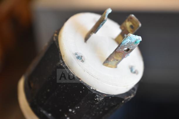 Close-up of an electrical plug for ServeWell Vollrath 38104 steam table, showing wear and oxidation.