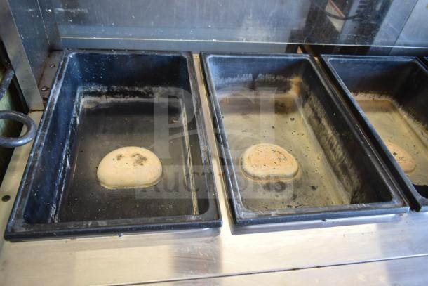 ServeWell Vollrath 38104 4 Well Steam Table on casters, 120V, used condition, visible wear in wells, commercial use.