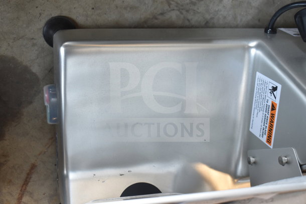 Brand new Globe G12 commercial slicer, visible scratches, warning label, 12" blade, blade sharpener included, 115V.