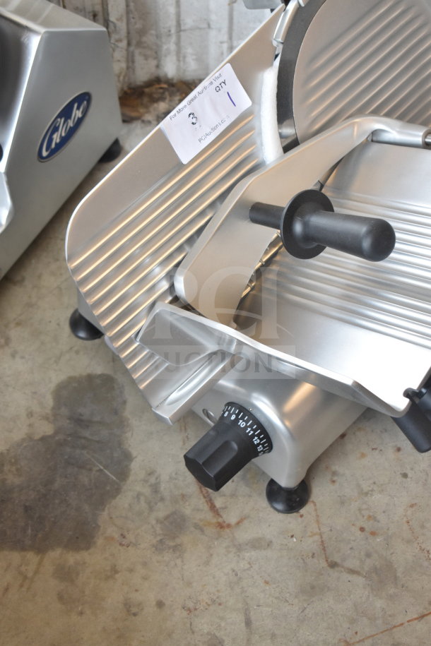 BRAND NEW Globe G12 commercial slicer with 12" blade, blade sharpener, voltage label, and minor scratches.