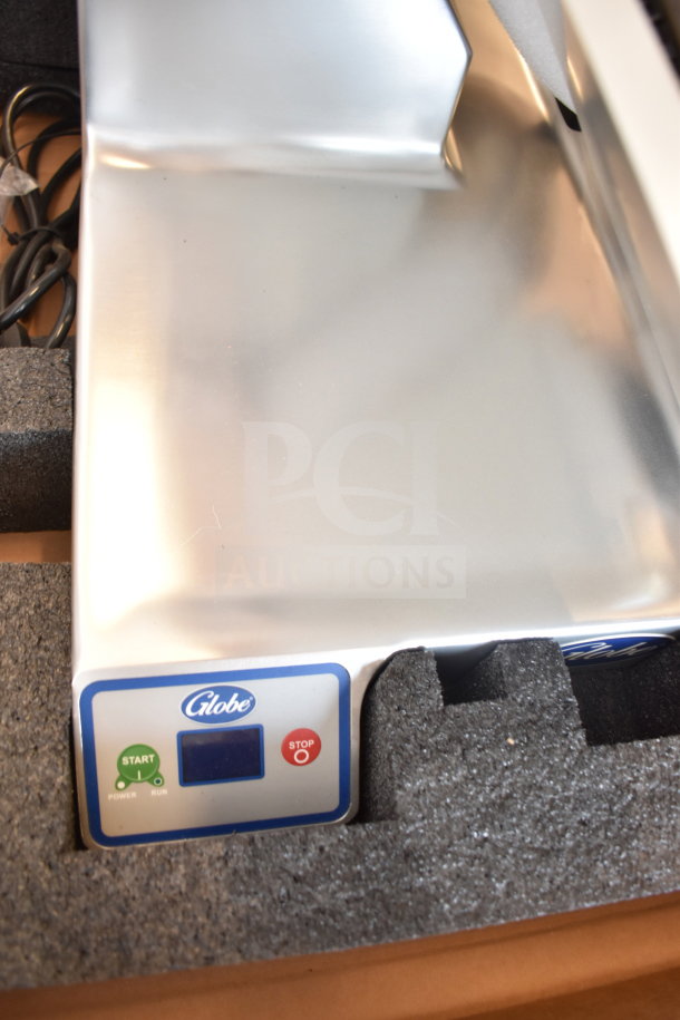 Brand new Globe SG13-84 slicer in original packaging, control panel visible. Automatic operation, 13" blade, 110V.