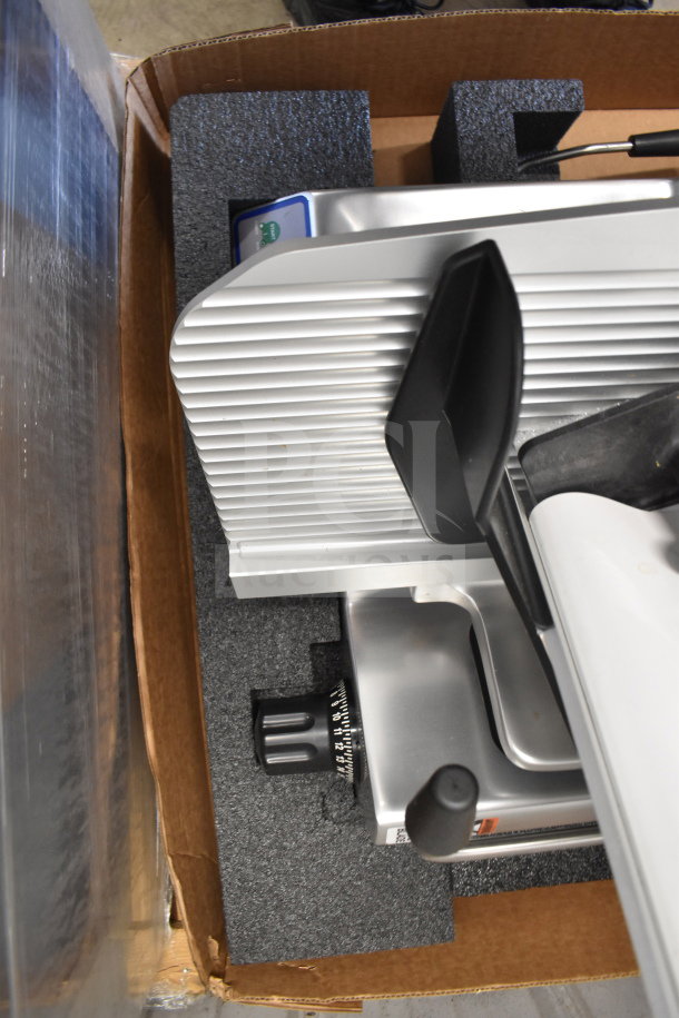 Brand new Globe SG13A commercial slicer with 13" blade, blade sharpener, in original packaging. 110V, 1 phase.