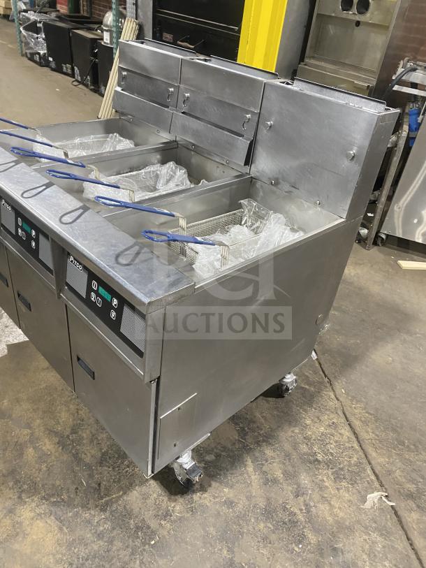 Pitco SG14-JS triple-bay fryer, stainless steel, digital controls, natural gas, 40 lb capacity, with baskets, on casters.