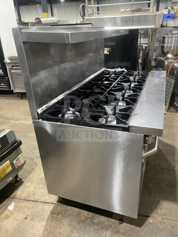 Bakers Pride 10-burner gas range with double oven, backsplash, overhead salamander shelf, and wired rack, Model 60BP10BS26N.