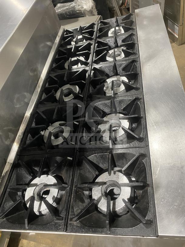 Bakers Pride 10-burner stainless steel gas range with double oven, model 60BP10BS26N, featuring backsplash, salamander shelf, and wired oven rack.