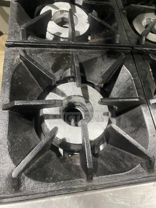 Bakers Pride 60BP10BS26N gas range close-up; cast iron burner, lightly used condition.