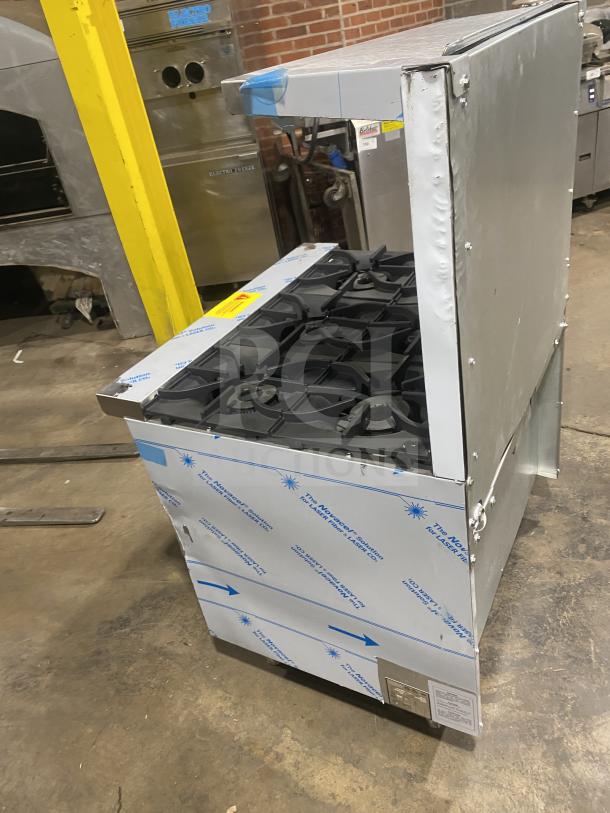 Kutano 36″ stainless steel gas range, model KUT-6-BR-N-36-N6, with 6 burners and oven. New condition with protective film.