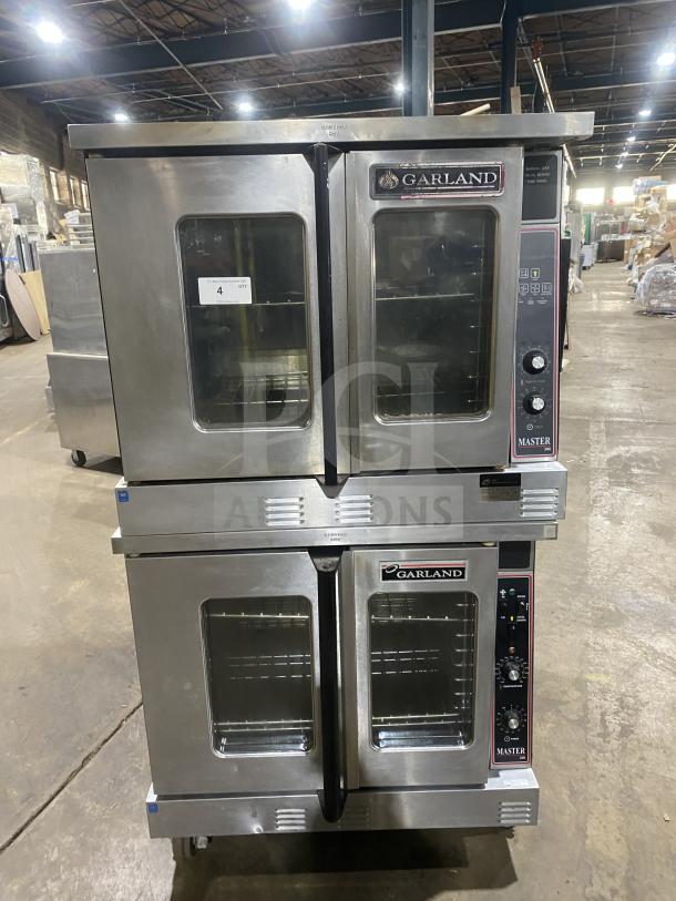Garland Master 300 stainless steel double stacked convection oven, natural gas powered, view-through doors, wire racks, on casters.